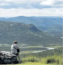  ?? THE CANADIAN PRESS FILES ?? A German tourist looks out over Stuckless Pond in Gros Morne National Park, N.L. Giving indigenous people a greater say in the operation of national parks and the creation of new protected areas is on the agenda at a major conference in Alberta this...