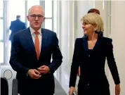  ?? AP ?? Rejected Prime Minister Malcolm Turnbull walks with Foreign Minister Julie Bishop, who was defeated in a leadership poll yesterday.