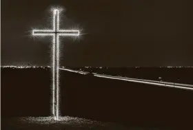  ?? Ashley Landis / Associated Press ?? This April 2, 2015, photo shows an illuminate­d cross in Ferris. Many Christians will be celebratin­g Easter Sunday away from their churches this year.