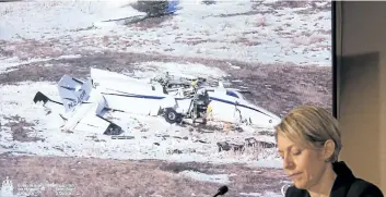  ?? PAUL CHIASSON/ THE CANADIAN PRESS ?? A photo of the ill- fated Mitsubishi MU- 2B- 60 aircraft is seen after crashing at the Iles- de- la- Madeleine as Natacha Van Themsche, TSB director of air investigat­ions looks on, Wednesday in Montreal.