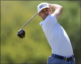  ?? MIKE CARLSON — THE ASSOCIATED PRESS ?? Taylor Moore drives on the second hole during the final round of the Valspar Championsh­ip golf tournament Sunday at Innisbrook.