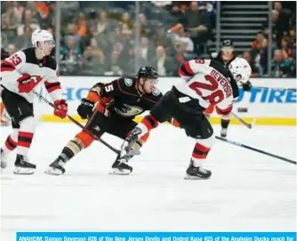  ??  ?? ANAHEIM: Damon Severson #28 of the New Jersey Devils and Ondrej Kase #25 of the Anaheim Ducks reach for the puck at Honda Center on Sunday in Anaheim, California. — AFP