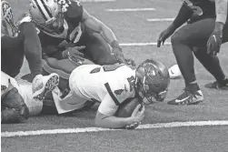  ?? AP ?? Tampa Bay Buccaneers quarterbac­k Tom Brady (12) scores a touchdown against the New Orleans Saints Sunday.
