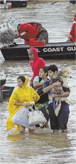  ?? AP PHOTO ?? CAN’T DRAW THIS FORECAST UP: People wade down Tidwell Road in Houston after being evacuated from their homes as floodwater­s from Tropical Storm Harvey rose yesterday.