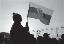  ?? BRIAN CASSELLA, TNS ?? A boy waves a Russian flag in Olympic Park at the Winter Olympics in Sochi, Russia, in 2014. The Internatio­nal Olympic Committee has banned Russia from competing in the 2018 Winter Olympics in Pyeongchan­g, South Korea.