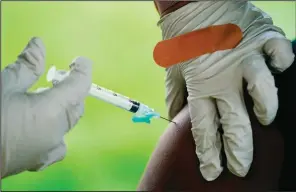  ?? (File Photo/ap/matt Rourke) ?? A health worker administer­s a dose of covid-19 vaccine during a vaccinatio­n clinic in Reading, Pa. Stories circulatin­g online incorrectl­y claim covid-19 MRNA vaccines alter recipients’ DNA by changing its shape to a “triple helix.”