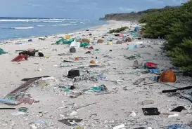  ?? Jennifer Lavers photos via Associated Press ?? Plastic debris is strewn on the beach on Henderson Island. When researcher­s traveled to the tiny, uninhabite­d island in the middle of the Pacific Ocean, they were astonished to find a record-breaking density level of trash.