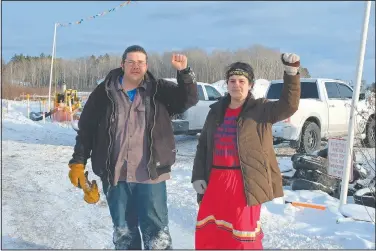  ?? (Indian Country Today/Mary Annette Pember) ?? Jason Goward and Taysha Martineau of the Fond du Lac tribe raise their fists in opposition to Enbridge’s Line 3 at Camp Migizi, a protest camp in Cloquet, Minn.
