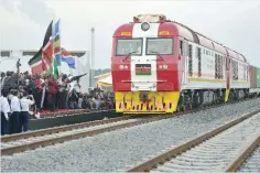  ?? —AFP ?? MOMBASA: This file photo taken on May 30, 2017 shows a cargo train with Kenyan President Uhuru Kenyatta on board as it leaves the container terminal at the port of the coastal town of Mombasa.