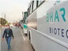  ?? AP ?? Below: An employee of Bharat Biotech walks to board a bus on the outskirts of Hyderabad.