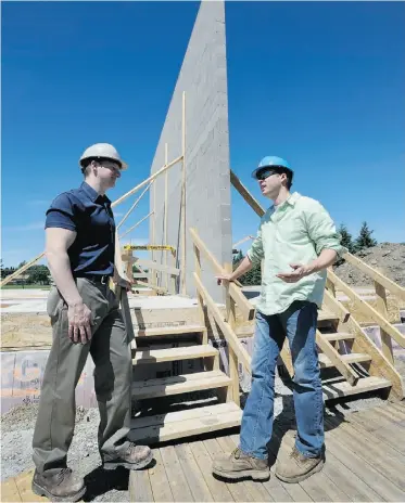  ?? Dan Riedlhuber, Postmedia News ?? Mark Hagel, left, and Kyle Keller discuss the Habitat for Humanity project in St. Albert.