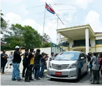  ?? AFP ?? Photograph­ers take pictures of a vehicle carrying embassy staff as it leaves N. Korean embassy in Kuala Lumpur on Wednesday. —