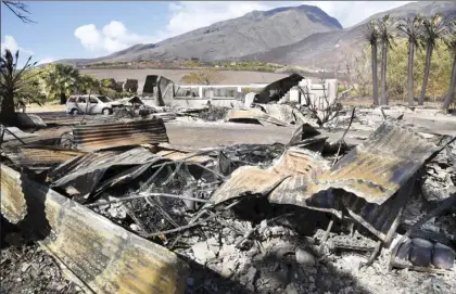  ?? The Maui News / MATTHEW THAYER photos ?? The Olowalu Lanakila Hawaiian Church’s social hall is reduced to rubble Monday. The social hall and two storage buildings were consumed by a wind-blown brush fire Saturday.