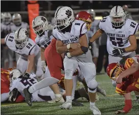  ?? PETE BANNAN – MEDIANEWS GROUP ?? Garnet Valley running back Shane Reynolds has both arms protecting the ball as he breaks into the open last Friday night late in a win over Haverford.