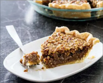  ?? DANIEL J. VAN ACKERE — AMERICA’S TEST KITCHEN VIA AP ?? This undated photo provided by America’s Test Kitchen in October 2018 shows classic pecan pie in Brookline, Mass. This recipe appears in the cookbook “All-Time Best Holiday Entertaini­ng.”