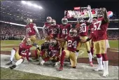  ?? TONY AVELAR — THE ASSOCIATED PRESS ?? San Francisco 49ers players celebrate after cornerback Richard Sherman, bottom center, intercepte­d a pass against the Green Bay Packers during the second half of the NFC Championsh­ip game Sunday in Santa Clara.