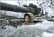  ?? LIBKOS — THE ASSOCIATED PRESS ?? A Ukrainian soldier looks out of a self-propelled artillery vehicle in the Donetsk region of Ukraine on Saturday.