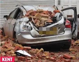  ??  ?? Crushed: A car is smashed by falling debris in Herne Bay