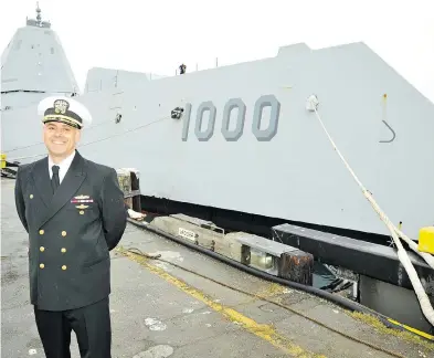  ?? DAVID PUGLIESE / POSTMEDIA NEWS ?? U.S. Navy Capt. Andrew Carlson, commander of the USS Zumwalt, stands on the jetty in Victoria at the bow of the futuristic stealth destroyer. The ship, one of three built for the American navy, cost $5.6 billion.