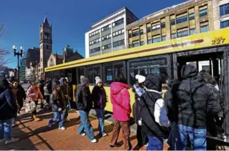  ?? DAVID L. RYAN/GLOBE STAFF ?? Copley Square area shuttles for the Green Line shutdown started Feb. 20, affecting commutes.