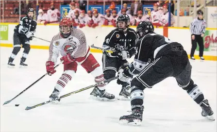  ?? JULIE JOCSAK THE ST. CATHARINES STANDARD ?? St. Catharines’ Lucas Smilsky, left, is double-teamed by Caledonia’s Matt West and Jack Wieringa in junior B playoff action Monday night at Jack Gatecliff Arena in St. Catharines.