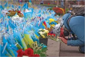  ?? AP PHOTO/ALEX BABENKO ?? A woman reacts Sunday on Independen­ce Square in Kyiv, Ukraine. The country held a national moment of silence to commemorat­e soldiers killed during its war with Russia.