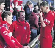  ??  ?? EARLY WIN Brora fans and players can celebrate title