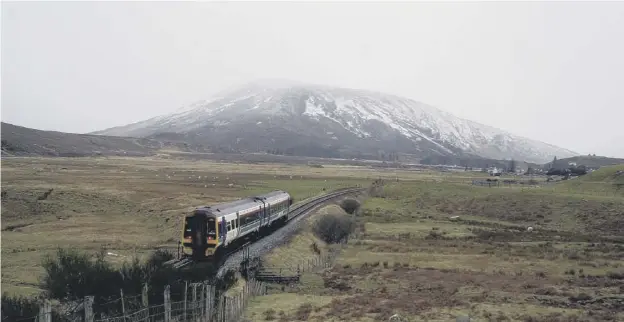  ??  ?? 0 A train passes Achnasheen on a remote moorland section of the line from Dingwall. Strathcarr­on station, right, at the start of its coastal section which stretches west to the original terminus at Strome Ferry and on to Kyle of Lochalsh