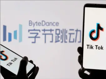  ?? -AFP ?? Tik Tok logos are seen on smartphone­s in front of a displayed ByteDance logo.