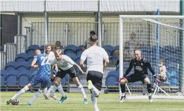  ??  ?? Posh pair Frankie Kent and David Cornell (right) prepare to try and block a shot from Chelsea’s Hakim Ziyech.