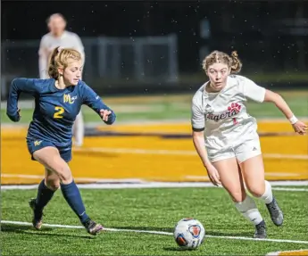  ?? For the Post-Gazette ?? Moon’s Hailey Longwell, right, dribbles upfield against Mars Wednesday night in the Class 3A semifinals — a 2-0 Moon victory.