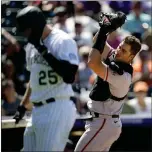  ?? ?? Giants catcher Joey Bart, right, fields a pop foul off the bat of the Rockies' C.J. Cron in the sixth inning on Wednesday in Denver.