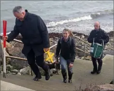  ??  ?? Above and below: Detective Sergeant Mick Troy, Maeve Sikora, Keeper of Irish Antiquitie­s at the National Museum of Ireland, and Garda Mark Power, at the scene of the find on Forlorn Point.