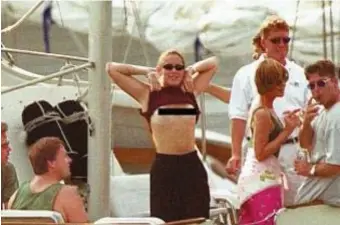  ?? MATT STONE / hERALD STAFF FILE ?? FIVE O’CLOCK SOMEWHERE: A woman flashes a Herald photograph­er aboard a boat with Massport bosses in 1999.