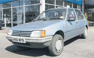  ?? ?? DEAL CLINCHED: Simon’s Peugeot 205 was perfect for his sales rep beat and a memorable trip to Glastonbur­y.