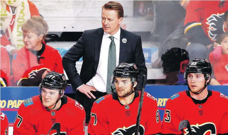  ?? — THE CANADIAN PRESS FILES ?? Flames coach Glen Gulutzan, top, was fired on Tuesday. Assistant coaches Dave Cameron and Paul Jerrard were also relieved of their duties.