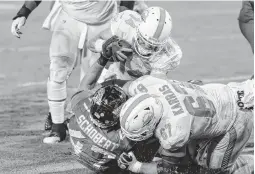  ?? GARY MCCULLOUGH/ASSOCIATED PRESS ?? Miami’s Ryan Fitzpatric­k dives for a touchdown over Jacksonvil­le Jaguars middle linebacker Joe Schobert on Thursday night. The Dolphins won 31-13.