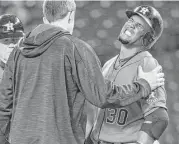  ?? Dean Rutz / Associated Press ?? Astros’ Carlos Gomez, right, took a painful pitch off his right hand Wednesday against the Mariners but was able to return Friday against the Athletics.