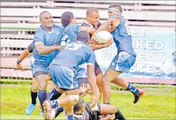  ?? Picture: JONA KONATACI ?? Naitasiri halfback Viliame Matai, with ball, is gang tackled by Yasawa players during their final Skipper Cup fixture at Ratu Cakobau Park in Nausori on Saturday.