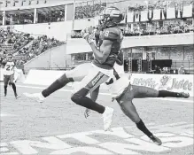  ?? JASON FRANSON THE CANADIAN PRESS ?? Eskimos’ Kenny Stafford makes a TD catch as Stampeders’ Tre Roberson tries to stop him Saturday in Edmonton. The Esks won the game, 48-42.