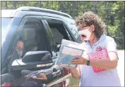  ??  ?? Sheryl Morrison, right, the Pupil Personnel Worker at Mt. Hope/ Nanjemoy Elementary School, outlines the Three Little Pigs STEM challenge, to parent Samantha Petrides. The challenge keeps students engaged over the summer.