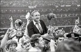  ?? AJC FILE ?? Vince Dooley, carried off the field after Georgia defeated Notre Dame in the Sugar Bowl for the national title in January 1981, also won six SEC championsh­ips.