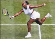  ?? Alastair Grant / AFP / Getty Images ?? Serena Williams returns against Barbora Strycova during their semifinal match Thursday at Wimbledon.