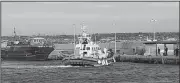  ?? AP/ELIO DESIDERIO ?? This photo taken on Friday and made available Monday shows the arrival of a Coast Guard boat carrying 18 migrants at the port of the Sicilian island of Lampedusa, southern Italy.