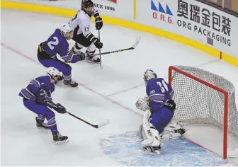  ?? STAFF PHOTOS BY MATT WEST ?? THAT WINNING FEELING: Plymouth South’s Alex Hayward (top) beats the Stoneham defense and goalie Peter Barry to score the game-winning goal in overtime, leading to a raucous celebratio­n (below) in the Division 2 final yesterday at the Garden.