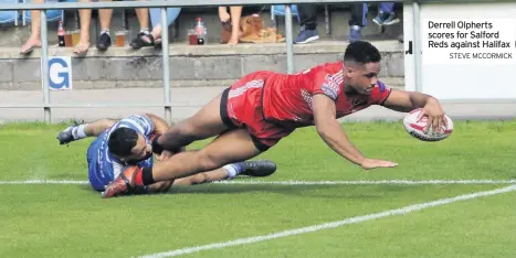  ??  ?? Derrell Olpherts scores for Salford Reds against Halifax