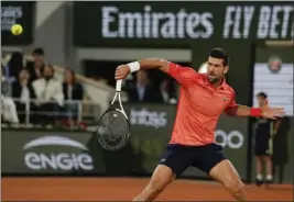  ?? THIBAULT CAMUS – THE ASSOCIATED PRESS ?? Novak Djokovic plays a shot during his second-round victory over Marton Fucsovics.