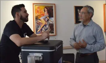  ??  ?? roberto Pozos (right) speaks with Calexico brewing Co. co-founder Jose Yepez about possibly collaborat­ing on artwork for future canned beer releases from the brewery. PHOTO JULIO MORALES