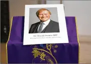  ?? ALBERTO PEZZALI/AP ?? An image of murdered British Conservati­ve lawmaker David Amess is displayed near the altar in St Peters Catholic Church before a vigil in Essex, England, Friday.