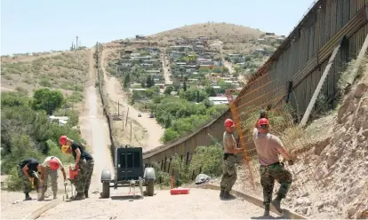  ?? AP FILES ?? National Guard troops work on building a road at the U. S.- Mexico border in Nogales, Arizona, in 2008.